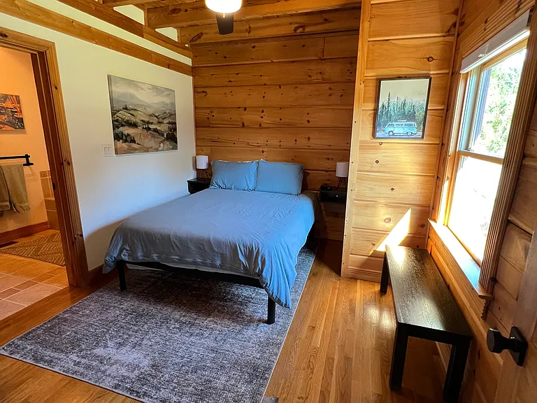Main floor bedroom, queen bed, off of the kitchen and family room.