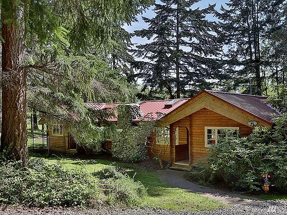 Situated amongst towering evergreens and over looking territorial views of lawn and garden sits this well maintained Pan Abode home with big deck!