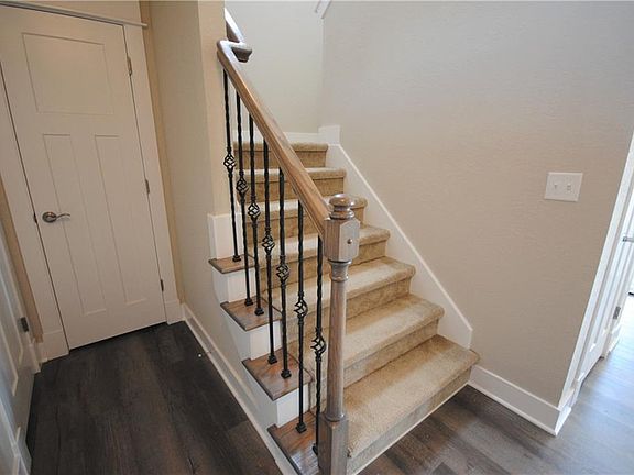 Exposed Oak Stained Stair Treads with Wrought Iron Spindles