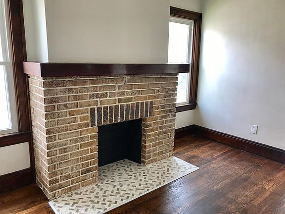 Fireplace w/ marble & travertine herringbone tile