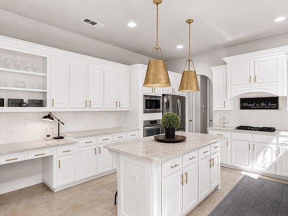 Light and bright kitchen Virtually staged with white paint and new pendants