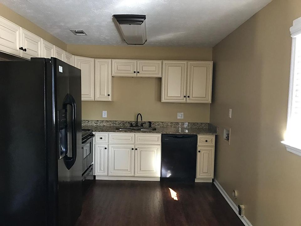 Kitchen with off white cabinets, granite counter tops and up