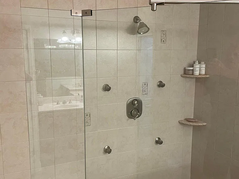Scandinavian-style walk-in shower with four full-body massage sprays