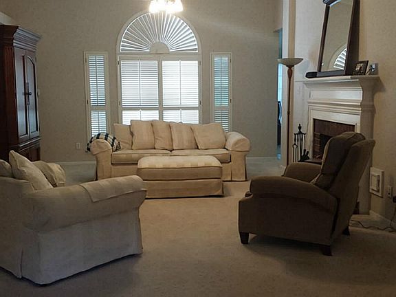 Large open living room with plush carpet
