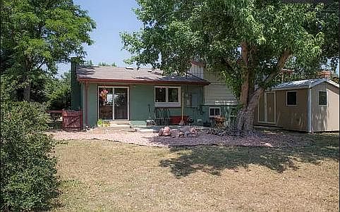 Backyard to the house (it's now painted grey).