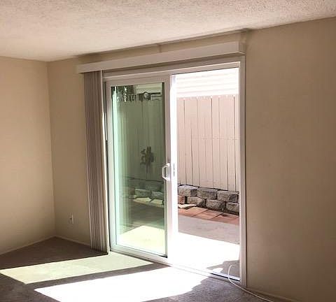 Living room area with patio access, also has a extra closet