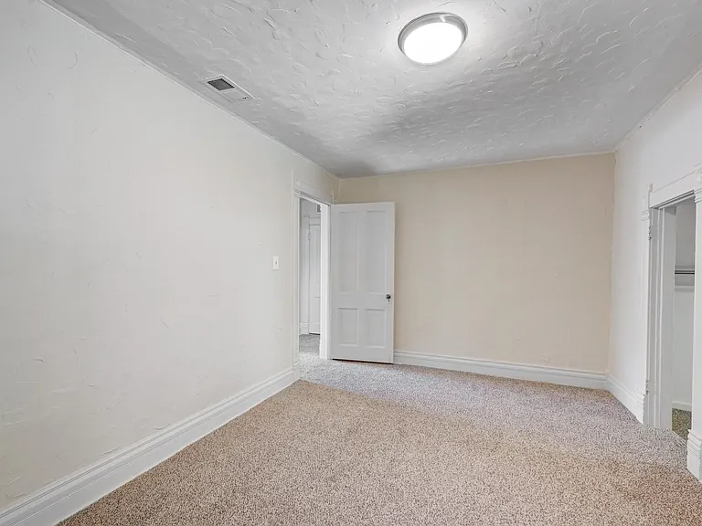 Primary upstairs bedroom has been freshly painted and the walk in closet features a long rod, cubby storage and a motion-sensitive light!