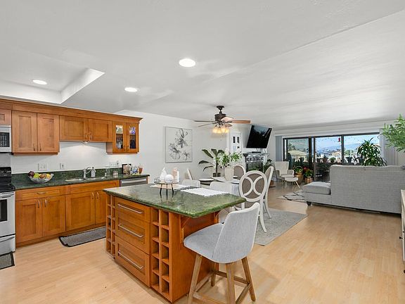 View from kitchen, towards dining area and living room.
Kitchen Island has cubbies for wine bottles