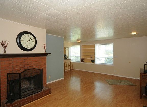 Gleaming Pergo flooring, and Wood burning fireplace