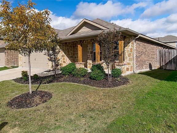 Austin stone and brick exterior with a covered porch.