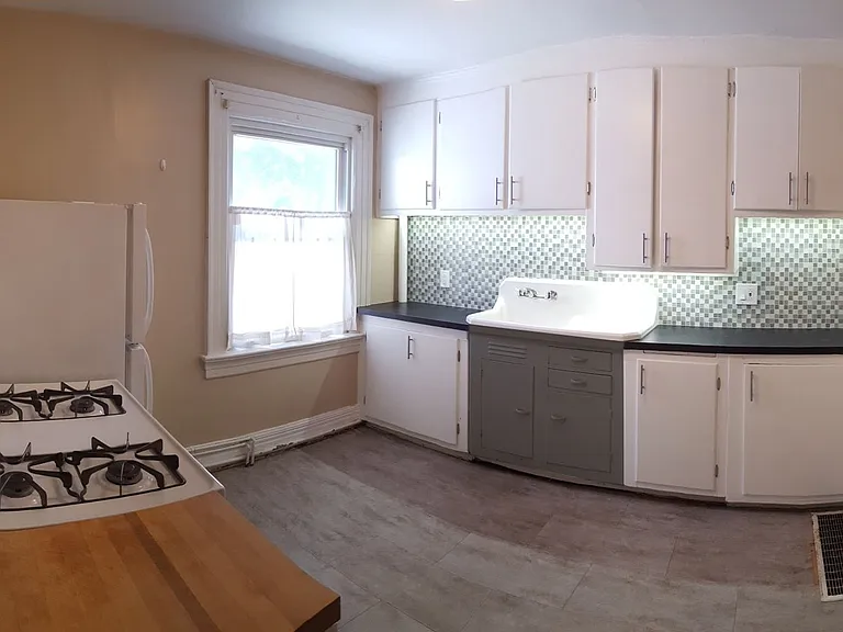 Kitchen with new appliances and farmhouse sink.