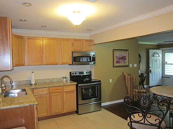 KITCHEN AND DINING, NEW GRANITE COUNTER TOPS, WOOD CABINETS, STAINLESS STOVE AND MICROWAVE OVEN