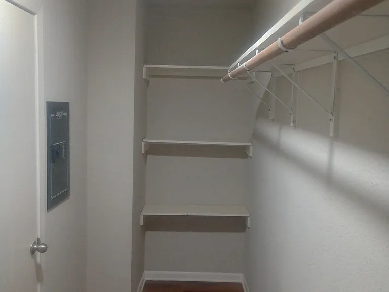 Master closet with original hardwood flooring and built-in safe.