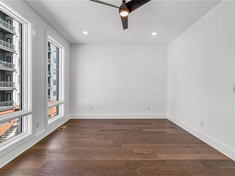 Main Bedroom (Note: Actual unit has light wooden floors and upgraded fixtures / appliances)
