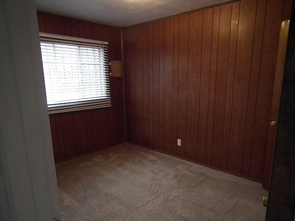 Back bedroom. There is sound proofing under that wood panel