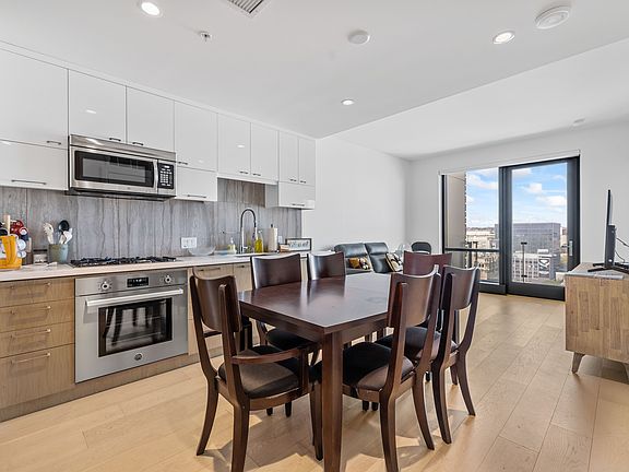 unfurnished kitchen, dining, and living room area