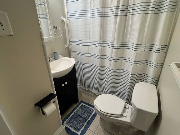 Bathroom with sit in tub and fresh linens