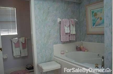 Master Bath : Bath has a sunken tub, a separate shower, sky light, vanity area and two sinks.