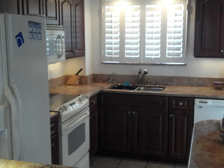 Kitchen - granite countertops and dishwasher and shutters