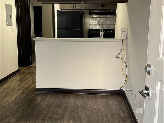 Standing in front door looking in.