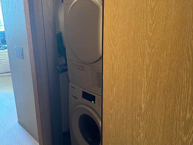 Hallway closet with washer and dryer