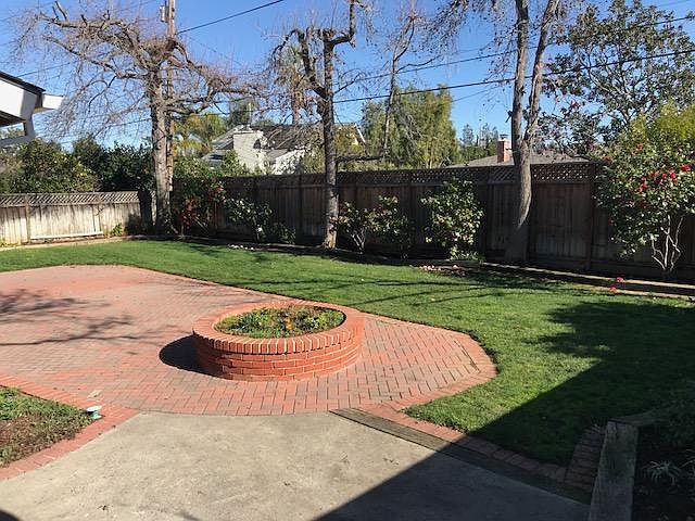 back yard with pavers for patio furniture use.
