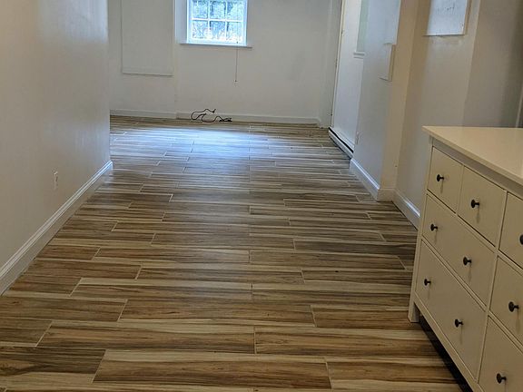 View from kitchen to living room area, now empty space