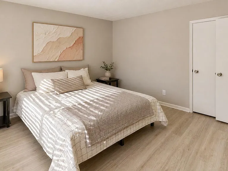 Furnished bedroom with a full-size bed, nightstands, and a closet for convenient everyday storage.