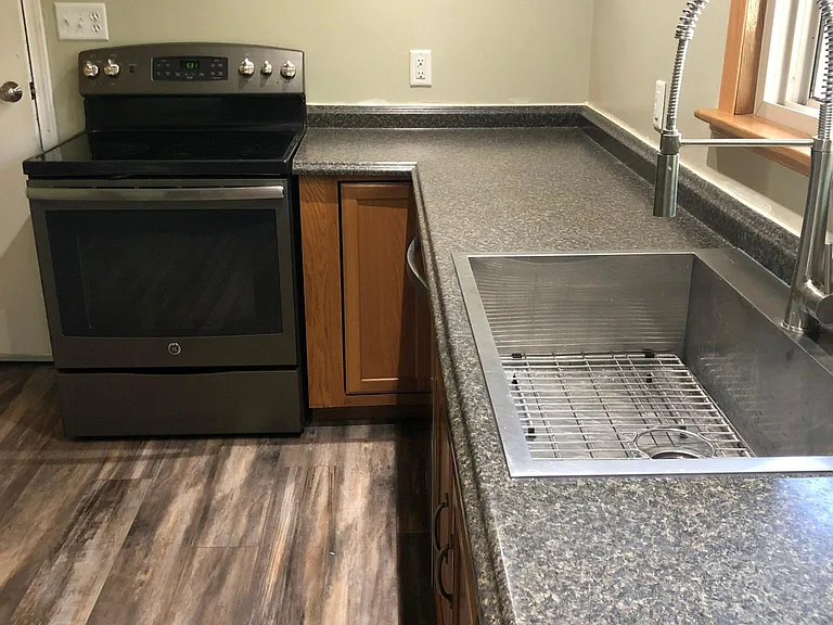 Kitchen facing garage door entrance.