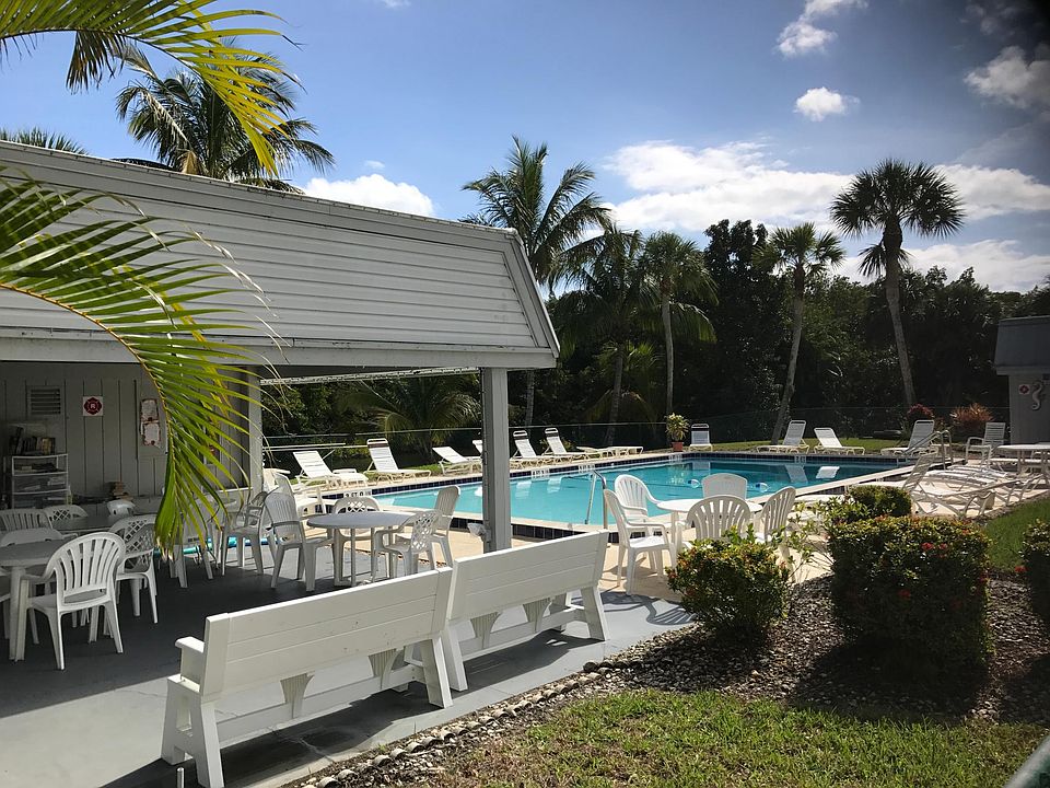 Cabana with restrooms and covered deck. Pool is heated with plenty of chairs and tables.
