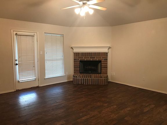 Woodburning fire place and wood tile floors make this a cozy living area!