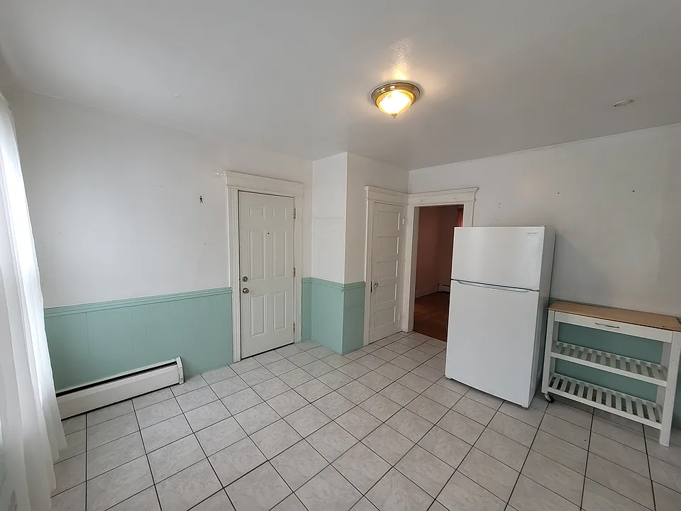 Large Eat-In Kitchen 
(main entry door on the left, pantry door in the center, doorway to Living Room on the right)