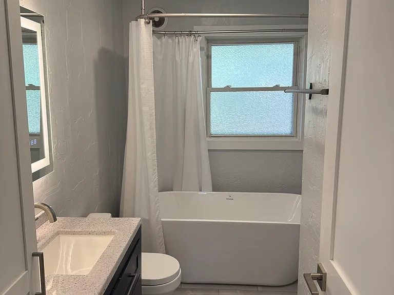 Main level bathroom with 70 inch freestanding tub.