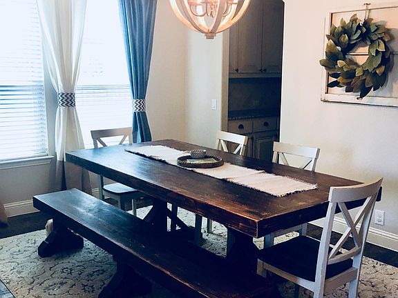 Large dining room off entry way features custom light fixtur