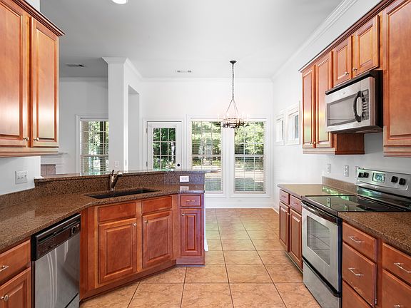 The kitchen features granite counters and stainless appliances.
