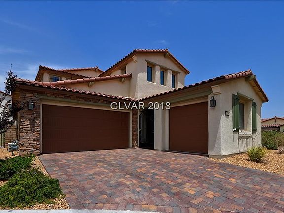 3 Car garage, cobblestone drive, wrought iron entry gate