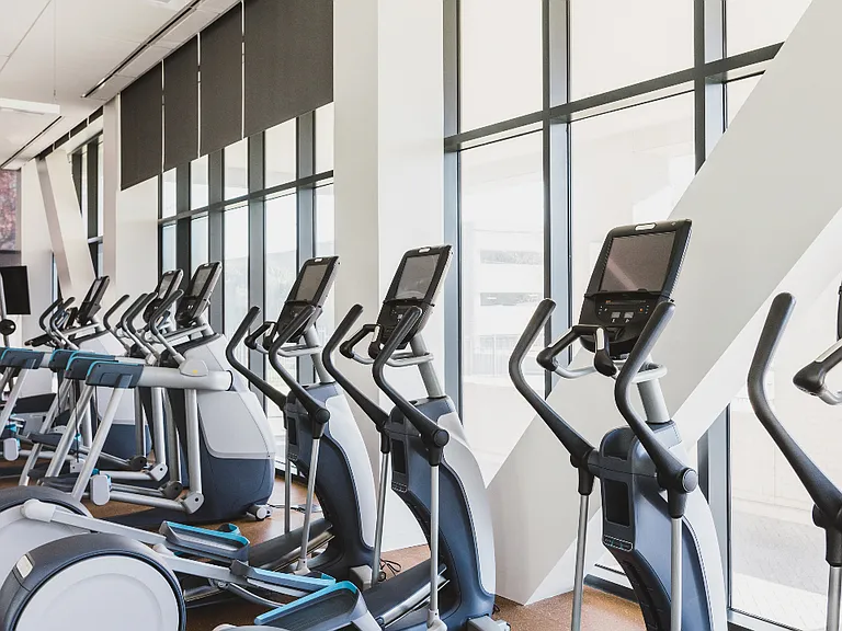 Floor to ceiling windows offer an open and airy atmosphere in our membership-style fitness center