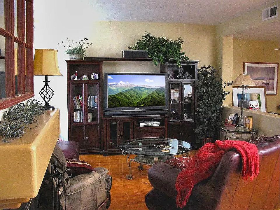 Living Room, with gas/wood burning fireplace (and mantel) at the foreground left.