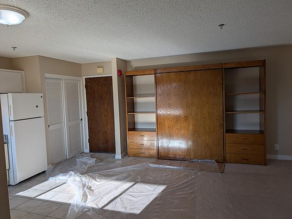 Storage shelves, drawers and Murphy's bed. Bedroom area has carpet floor. Unit close to elevator hallway.