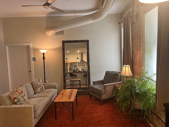 Living area with door to utility closet with washer and dryer