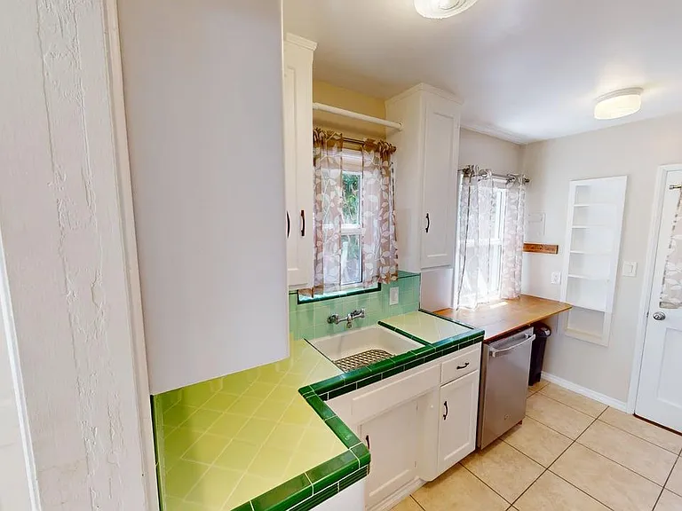 shows the dishwasher under wood counter