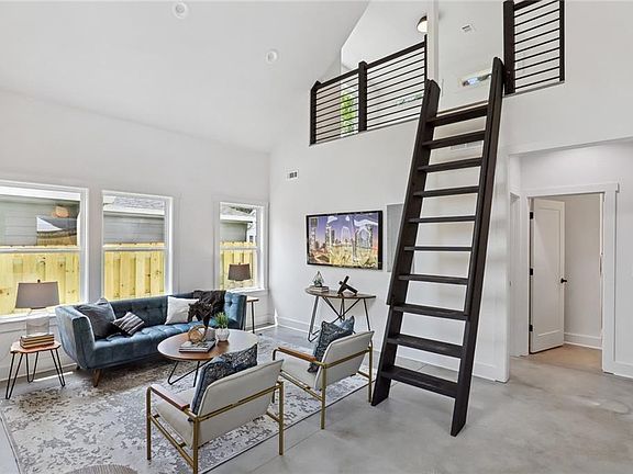 living area and ladder to loft