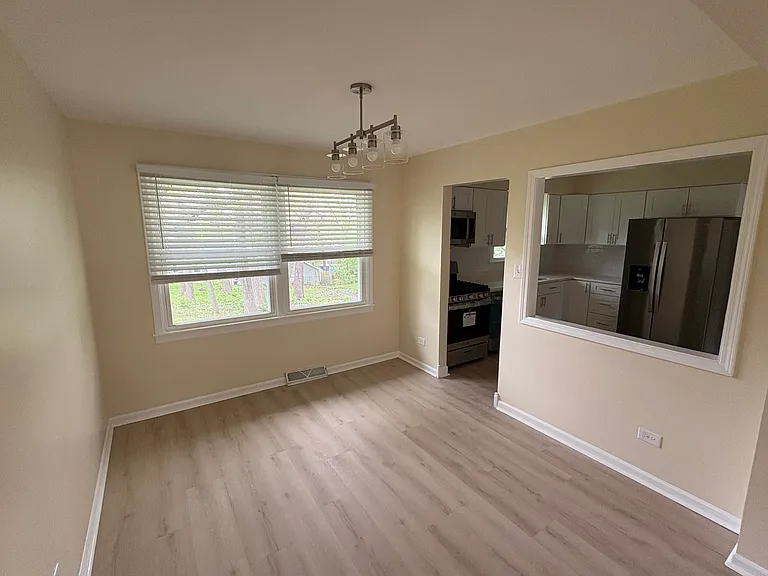 Dining Room leading into the kitchen, overlooking the spacious back yard