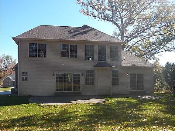 Exterior Back. Rear view of the property.  Sliding doors off of the kitchen and another set off of the master suite lead to the patio.