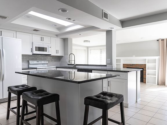 Completely renovated kitchen with large island, new cabinets, and granite countertops.