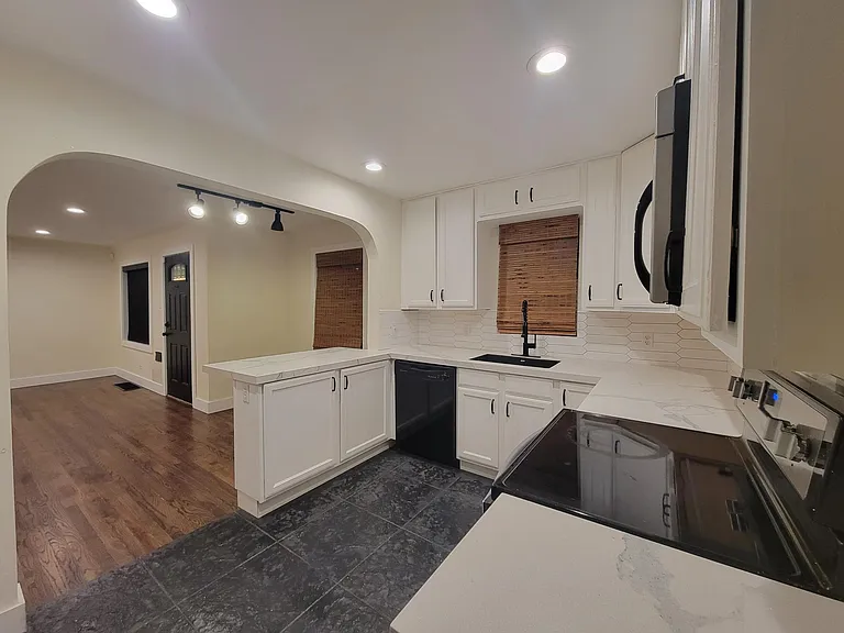 Refinished cabinets, new backsplash, quartz countertops, refinished tile floors