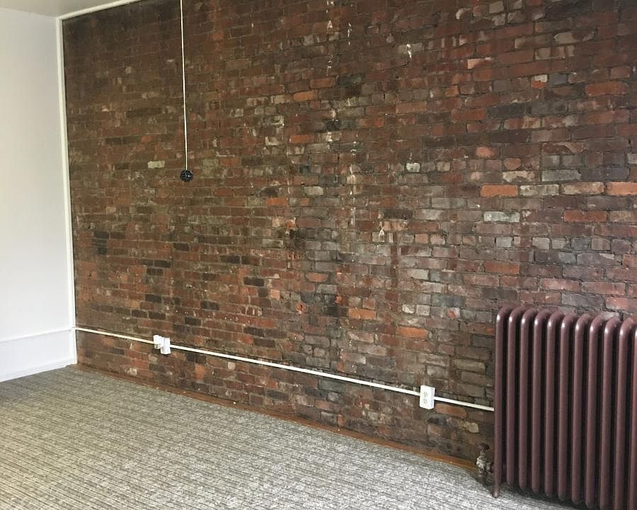 Exposed brick wall in living area.