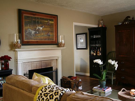 Large living room w/ fireplace that opens to dining room.