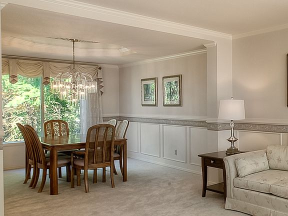 The formal dining room has a lovely view of the wooded greenbelt.