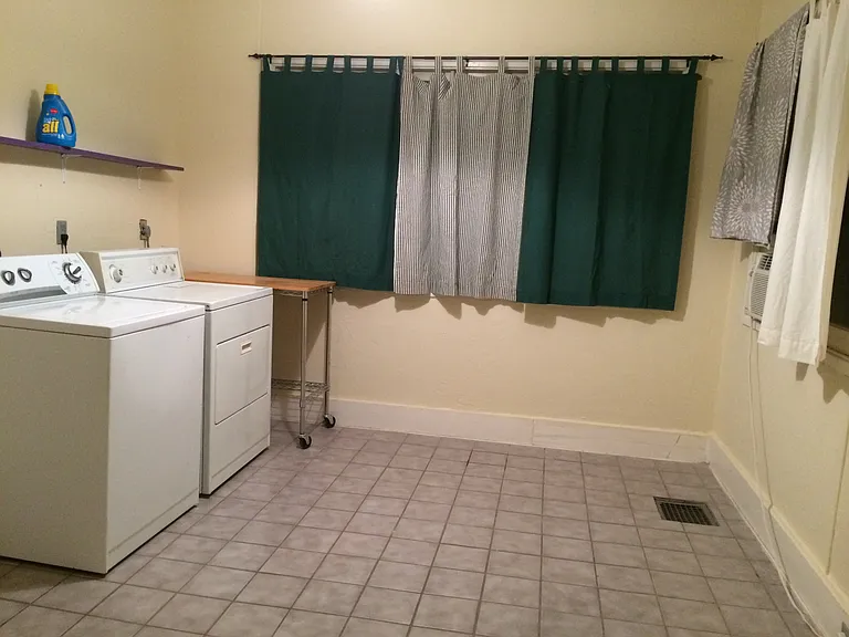 Dining area/ laundry, west part of kitchen, door to backyard to the left